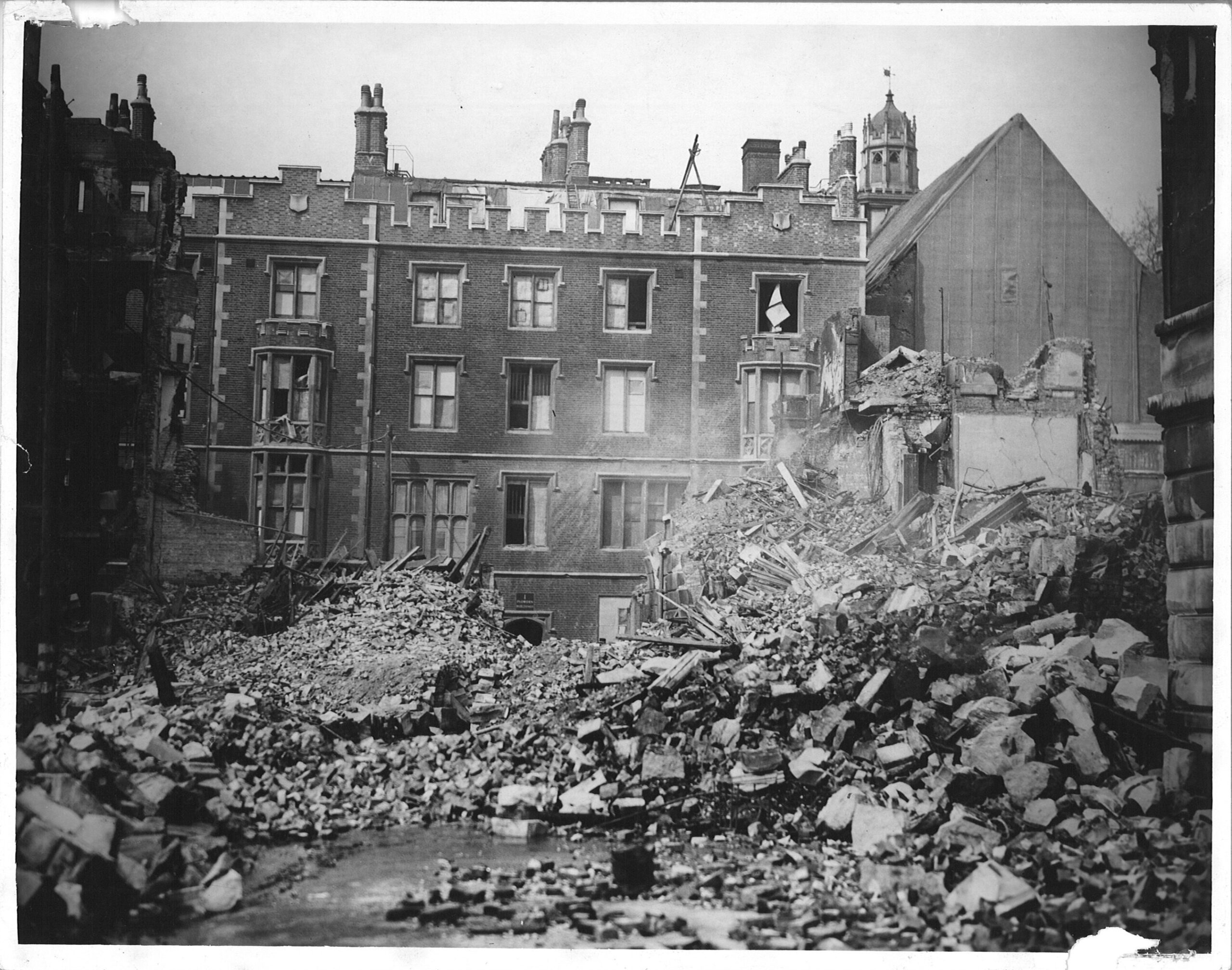 Plowden buildings still standing with debris in front