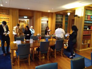 Various students looking at clues in the Library